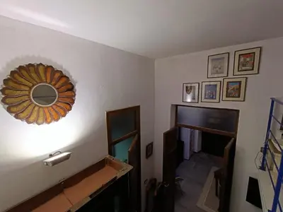 a living room with a mirror on the wall at Syd's House in Bagheria