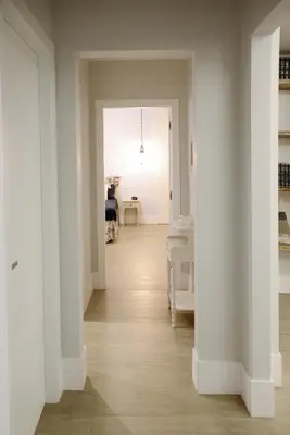 a hallway with white walls and wooden floors and a room at Villa Rosina in Cinisi