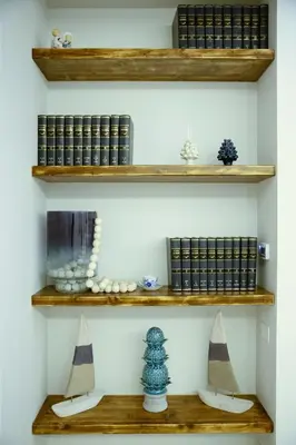a room with wooden shelves with books at Villa Rosina in Cinisi