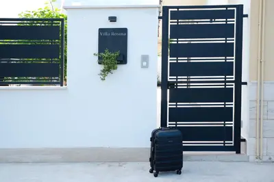 a suitcase sitting in front of a door at Villa Rosina in Cinisi