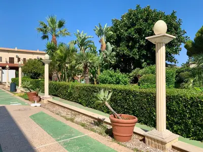a potted plant in a pot next to a pole at Blue Coral in San Vito lo Capo