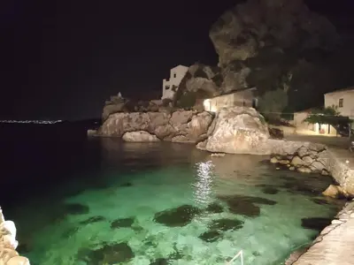 a large body of water at night at Villa Corallo Sicily - Scopello Guidaloca Bay in Scopello
