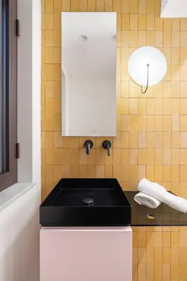 a white kitchen with a black counter top at A Casa di Giulia - elegante loft in centro storico in Palermo