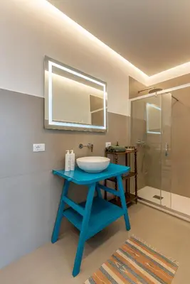 a bathroom with a blue table with a sink and a shower at Appartamento a due passi da Villa Trabia by Wonderful Italy in Palermo