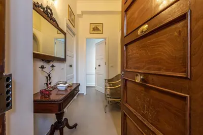 a hallway with a wooden door and a table at Appartamento a due passi da Villa Trabia by Wonderful Italy in Palermo