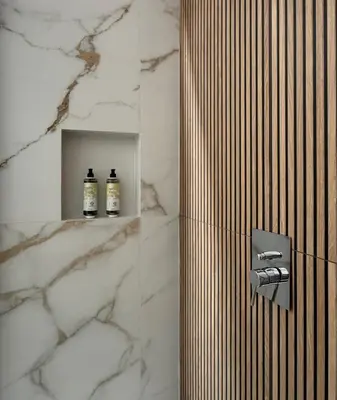 a bathroom with a shower with two bottles on a shelf at Kanisa Mari e Monti in Cinisi