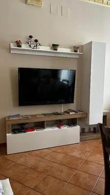 a flat screen tv on a white entertainment center at Laura Affittacamere in Palermo