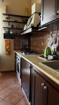 a kitchen with a stove and a sink and a microwave at Laura Affittacamere in Palermo