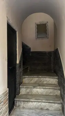 an entrance to a building with stairs and a door at Laura Affittacamere in Palermo
