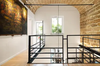 a staircase in a room with a brick wall at The Garden Boutique Apartment by DomuSicily in Palermo