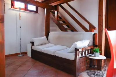 a couch sitting in the corner of a room at Cattedrale - VISTA HOUSE easy parking in Palermo