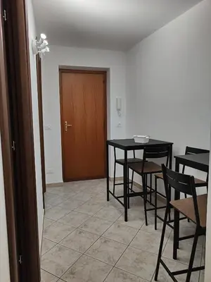 a dining room with a table and chairs and a door at Casa Josè Suite Mare in Palermo
