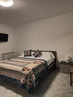a bedroom with a bed with a comforter and pillows at Casa Josè Suite Mare in Palermo