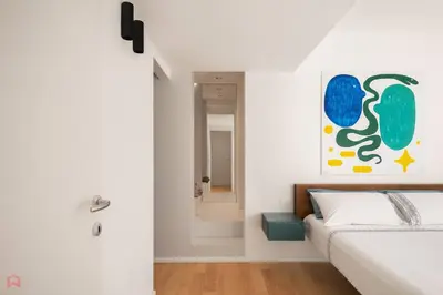 a bedroom with a bed and a painting on the wall at Sea View Villa whit Pool in Scopello