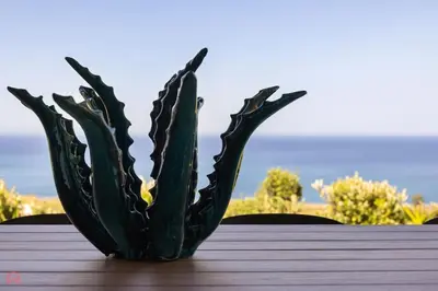 a green cactus sitting on top of a table at Sea View Villa whit Pool in Scopello