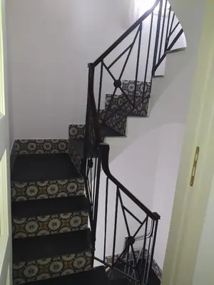 a set of stairs with wrought iron railings at Casa Lo Re in Santa Flavia