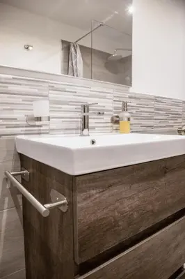 a bathroom with a white sink and a mirror at Casa vacanze Rigano Palermo in Palermo