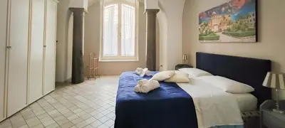 a bedroom with a bed with two stuffed animals on it at Dimora Artale in Cattedrale in Palermo