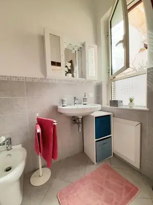 a bathroom with a sink and a toilet and a mirror at La comodità a due passi dal mare di Mondello in Mondello