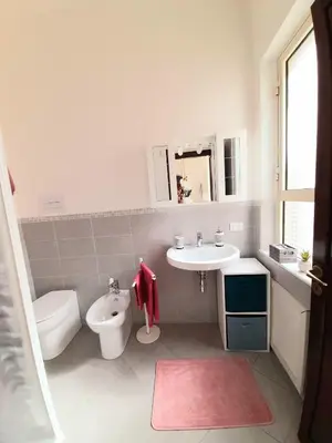 a bathroom with a toilet and a sink at La comodità a due passi dal mare di Mondello in Mondello