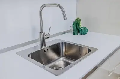 a stainless steel kitchen sink in a white kitchen at Villa delle Palme in Campofelice di Roccella