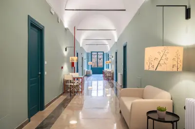 a living room with a couch and a table at Casa San Francesco Rooms in Palermo