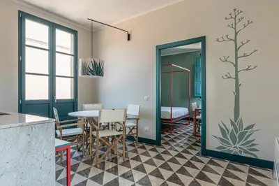 a dining room with a table and chairs at Casa San Francesco Rooms in Palermo
