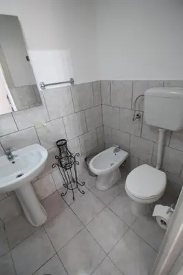 a bathroom with a toilet and a bidet and a sink at Case Billeci Casa blu in Palermo