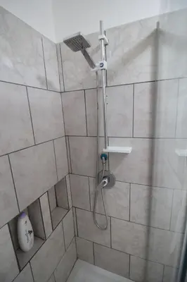 a shower with a shower head in a bathroom at Case Billeci Casa blu in Palermo