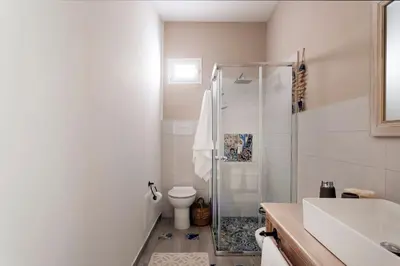 a bathroom with a shower and a toilet and a sink at Villa Marina Sant'Elia in Santa Flavia