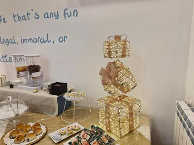a table topped with plates of food and a sign that reads think thats any at Politeama Center in Palermo