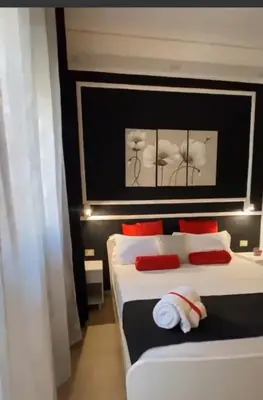 a bedroom with two beds with red pillows at Politeama Center in Palermo