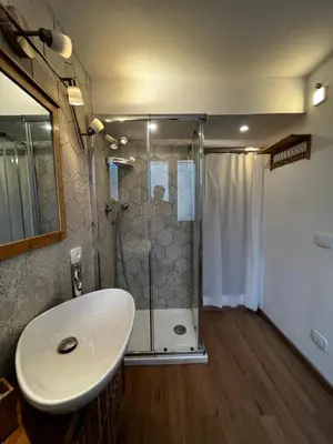 a bathroom with a shower and a white sink at A casa del Conte in Palermo
