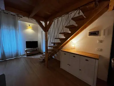 a room with a staircase and a living room at A casa del Conte in Palermo