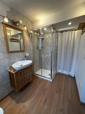 a bathroom with a glass shower and a sink at A casa del Conte in Palermo