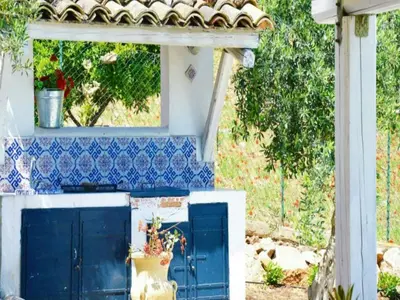 a white table with white chairs and an umbrella at Villa Antico Pozzo piscina privata SPA in Castellammare del Golfo