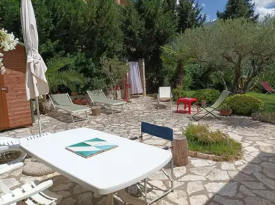 a patio with a white table and chairs at Villetta sulla Valle in Castellammare del Golfo