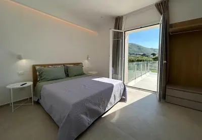 a swimming pool with two chairs and a house at Civetta Blu in Castellammare del Golfo