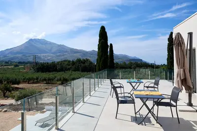 a view of a garden with trees and a swimming pool at Civetta Blu in Castellammare del Golfo
