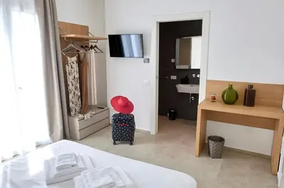 a bedroom with a bed and large windows at Civetta Blu in Castellammare del Golfo