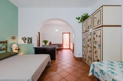 a bedroom with two beds and a desk in a room at GuestHost - Teatro Politeama Functional Studio x4 in Palermo