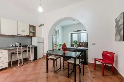 a kitchen and dining room with a table and chairs at GuestHost - Teatro Politeama Functional Studio x4 in Palermo