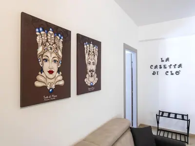a living room with three posters on the wall at Apartment La Casetta di Clò by Interhome in Palermo