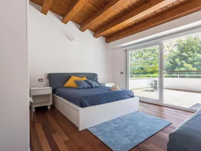 a bedroom with a bed and a large window at Apartment Quirat Superior by Interhome in Terrasini