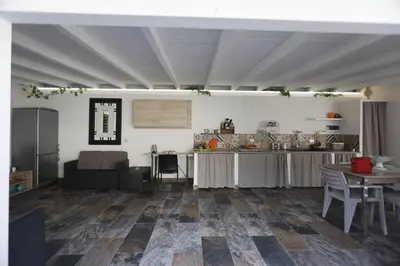 a kitchen and dining room with a table and chairs at Al Cottage Isola Delle Femmine in Isola delle Femmine