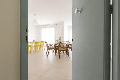 a dining room with a table and chairs at Visitsicilia Rosetta Mare in Alcamo Marina