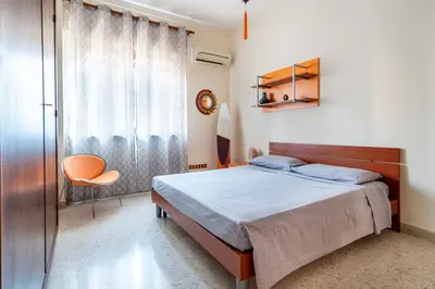 a bedroom with a bed and a window at Casa Lov (Politeama) in Palermo