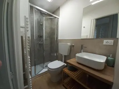 a bathroom with a toilet and a shower and a sink at Casa Ranzano in Palermo