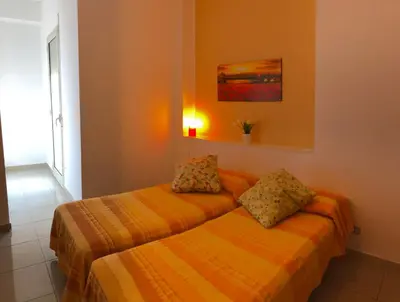 two twin beds in a room with a window at Villa Gelvi in Castellammare del Golfo