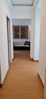 a hallway with a bed in a white room at Di Fresco Apartments Luxury Suites in Palermo